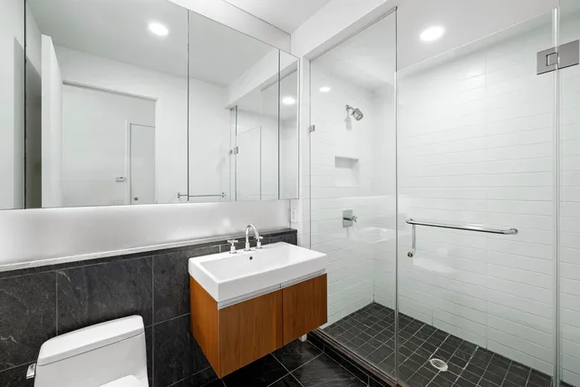 a large bedroom with a bed and wooden floor