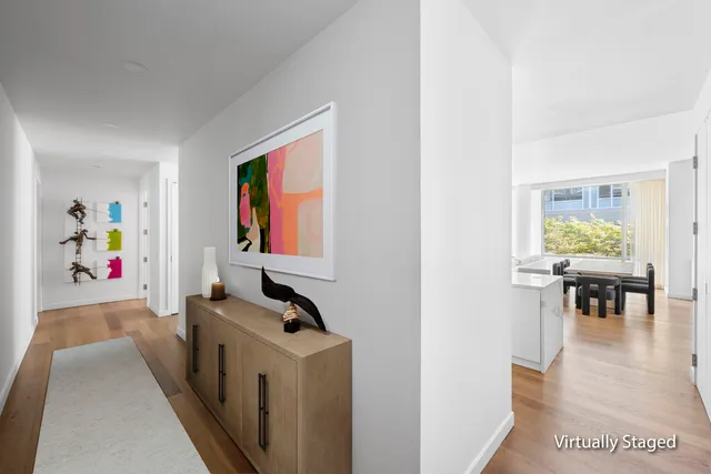 a view of a bedroom with a bed and wooden floor
