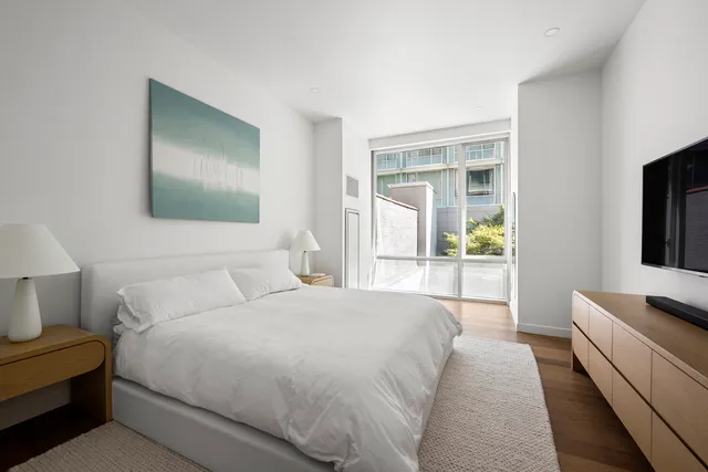 a view of a hallway with wooden floor and dining room