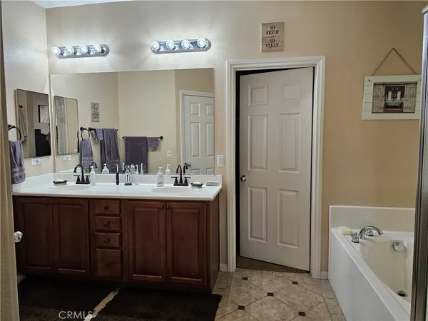a bathroom with a sink a toilet a mirror and shower