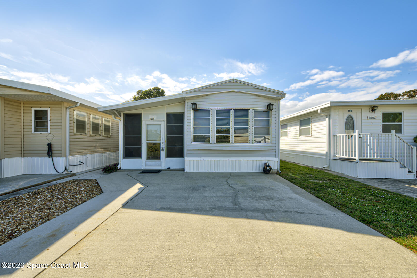 a front view of a house with a yard and glass windows