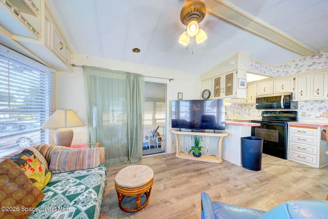 a kitchen with a refrigerator and a stove top oven