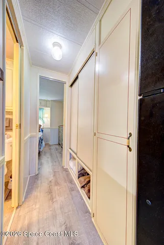 a view of a hallway with large mirror and furniture