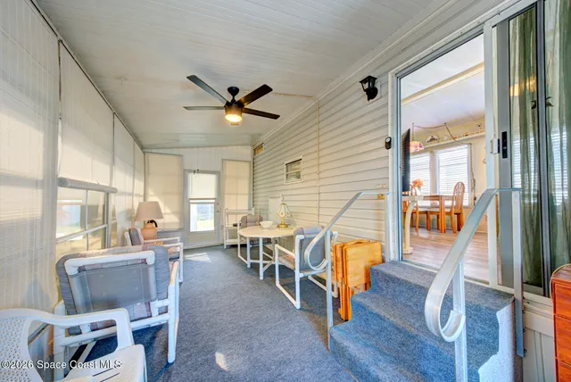 a view of a dining room with furniture a chandelier and wooden floor