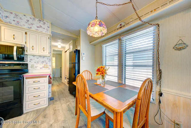 a dining room with furniture and a chandelier
