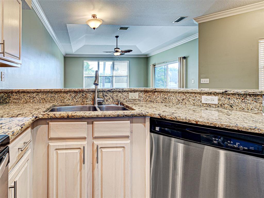 1801 Highland Road Osprey, FL 34229 - Photo 13 of 40 a kitchen with granite countertop a sink and cabinets