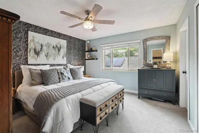 a bedroom with a bed a window and dresser