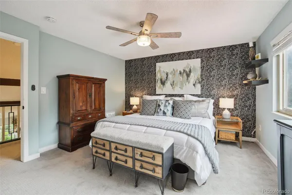 a bedroom with a bed and a chandelier