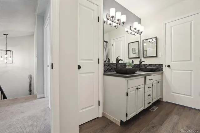 a bathroom with a sink vanity and mirror
