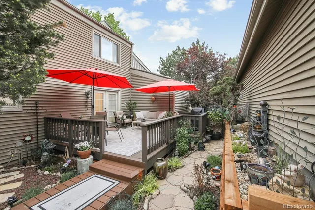 a view of a patio with couches chairs under an umbrella