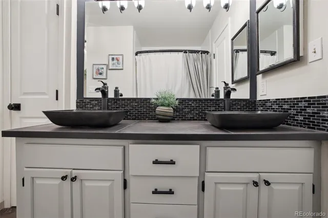 a kitchen with a sink and white cabinets