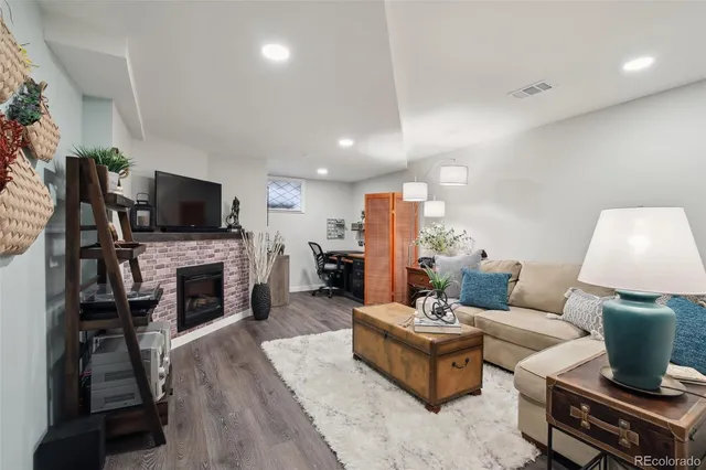 a living room with furniture a fireplace and a flat screen tv