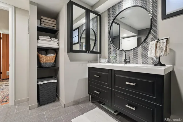 a bathroom with a sink and a mirror
