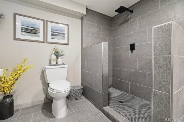 a bathroom with a toilet sink and shower