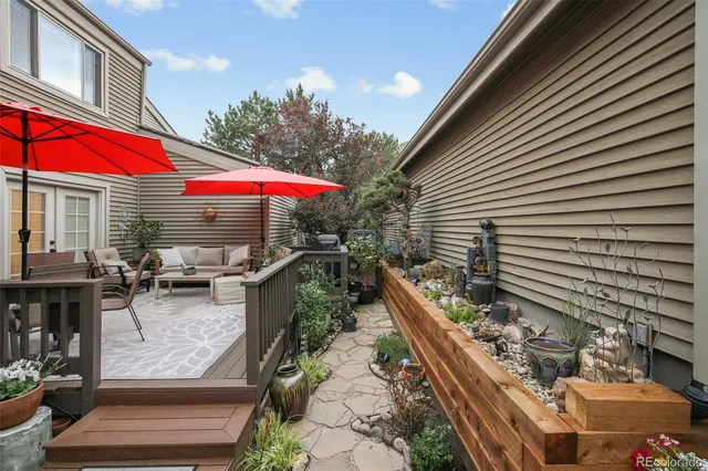 a view of a house with a yard and sitting area