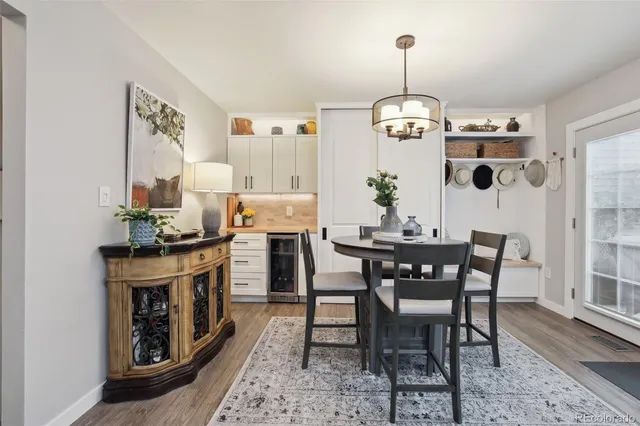 a view of a dining room with furniture wooden floor and a chandelier