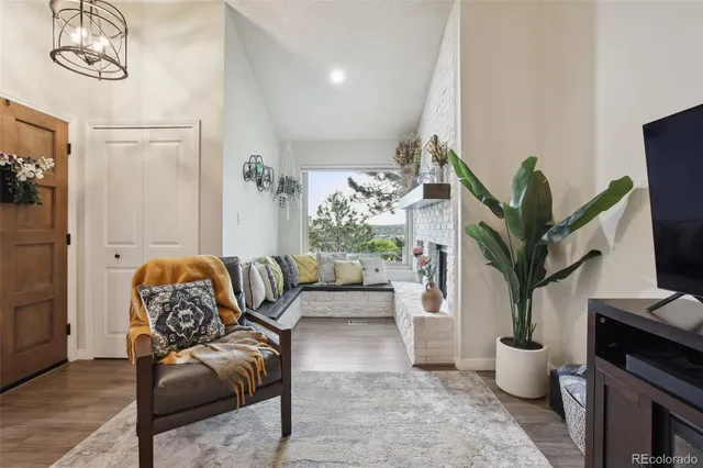 a living room with furniture potted plant and a chandelier