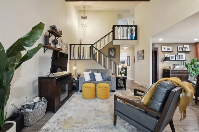 a living room with furniture rug and wooden floor