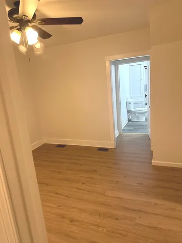 a view of a room with wooden floor
