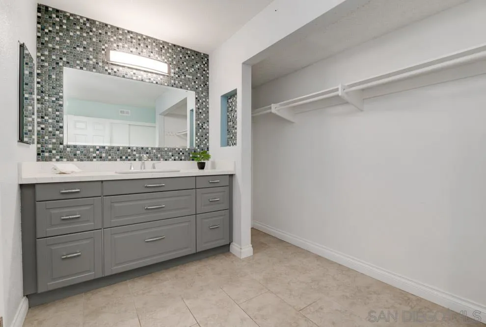 6357 Rancho Mission Road, Unit 1 San Diego, CA 92108 - Photo 13 of 28 a bathroom with a double vanity sink mirror and