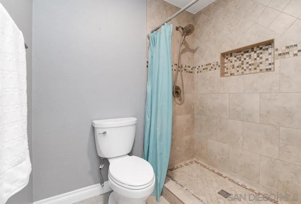 6357 Rancho Mission Road, Unit 1 San Diego, CA 92108 - Photo 14 of 28 a white toilet sitting next to a bath tub shower