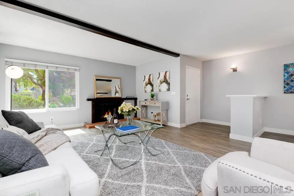 6357 Rancho Mission Road, Unit 1 San Diego, CA 92108 - Photo 2 of 28 a living room with furniture and a fireplace