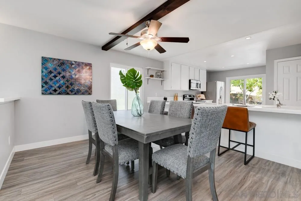 6357 Rancho Mission Road, Unit 1 San Diego, CA 92108 - Photo 5 of 28 a view of a dining room with furniture and wooden floor