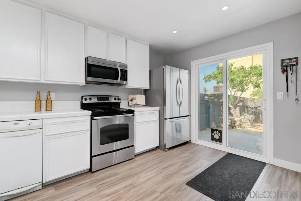 6357 Rancho Mission Road, Unit 1 San Diego, CA 92108 - Photo 8 of 28 a kitchen with a refrigerator stove and microwave