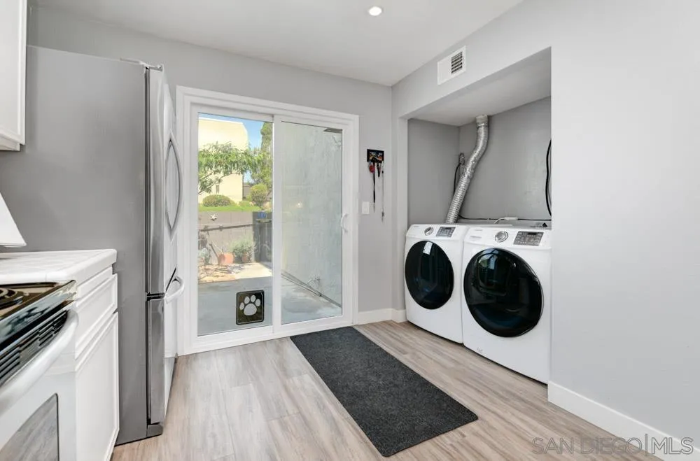 6357 Rancho Mission Road, Unit 1 San Diego, CA 92108 - Photo 9 of 28 a view of a kitchen with washer and dryer