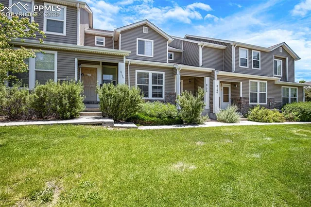a front view of house and yard with green space