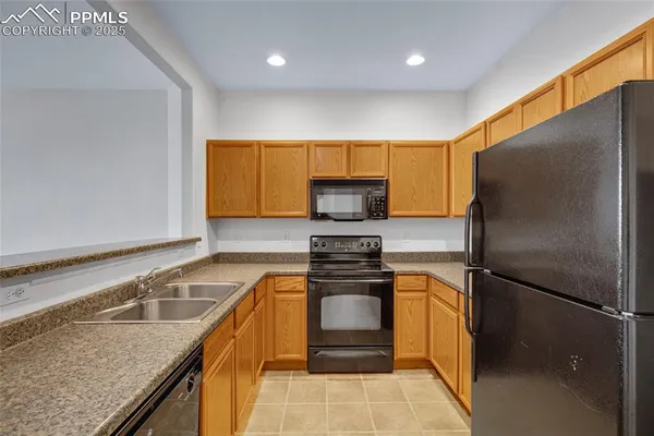 a kitchen with a refrigerator sink and stove