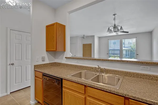 a kitchen with a sink cabinets and window