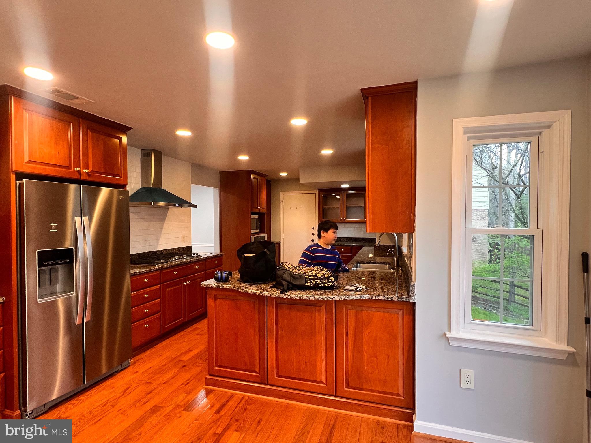 1509 Snughill Court Vienna, VA 22182 - Photo 1 of 12 a kitchen with stainless steel appliances granite countertop a refrigerator and a sink