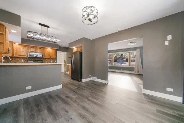 a view of an empty room with a fireplace and a window