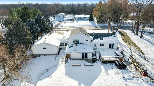 a view of an empty room with wooden floor and closet