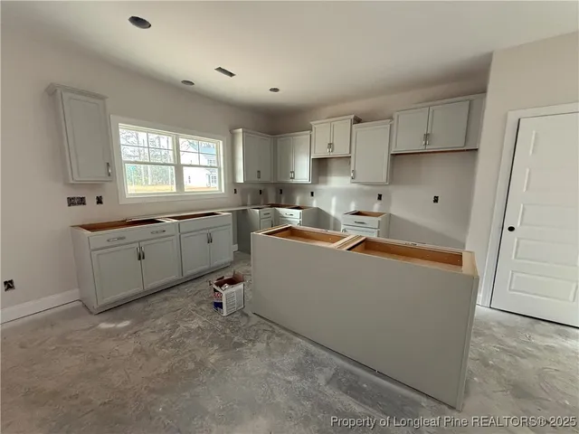 a room with cabinets a sink and appliances