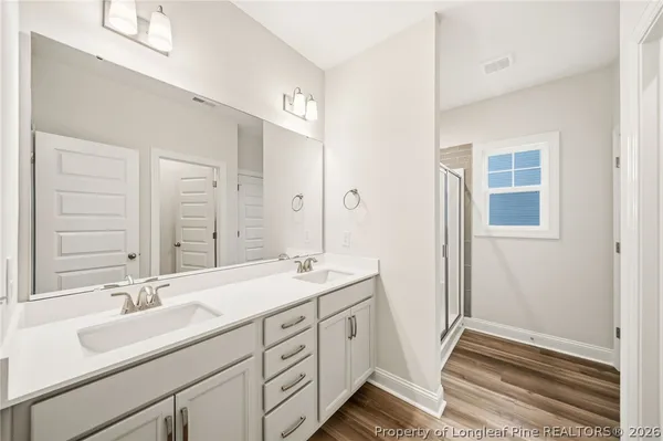 a bathroom with a sink double vanity and a mirror