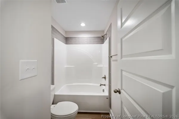a bathroom with a toilet and a bathtub