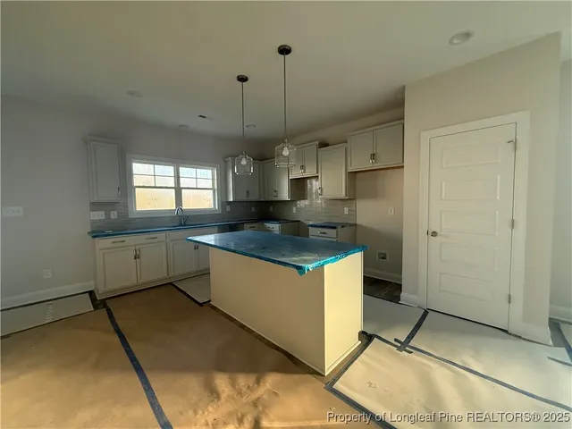 a large kitchen with cabinets and a stainless steel appliances