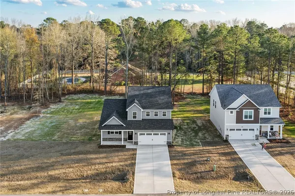an aerial view of a house with a yard