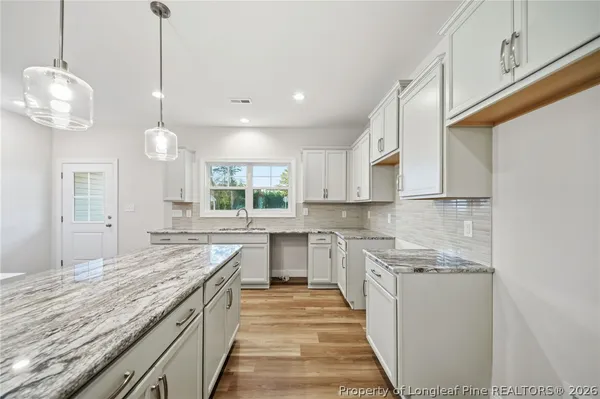 a kitchen with stainless steel appliances granite countertop sink stove and cabinets