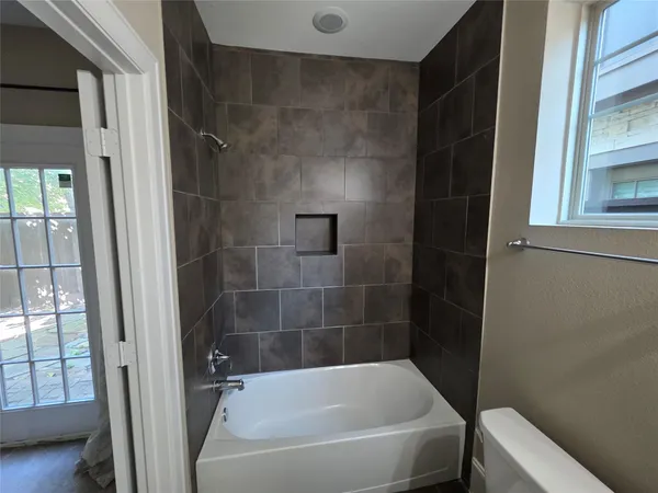 a white bath tub sitting next to a small sink
