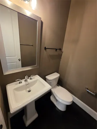 a white toilet sitting next to a bathroom sink