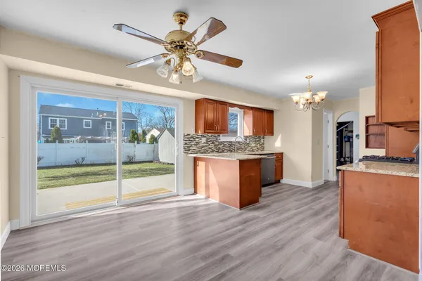 a view of a house with a yard and wooden fence