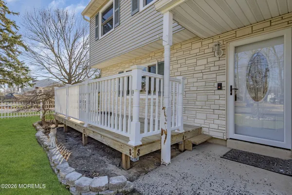 a kitchen with granite countertop cabinets sink and wooden floor