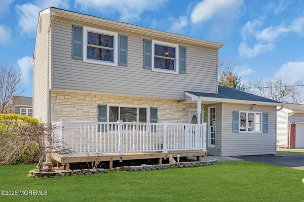 a view of a house with a backyard