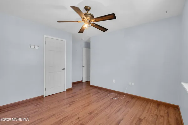 a view of a room with wooden floor and window
