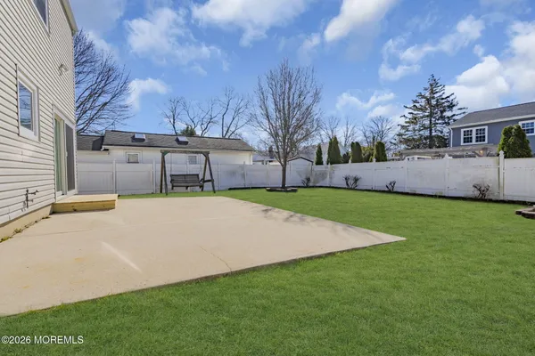 a view of house with backyard