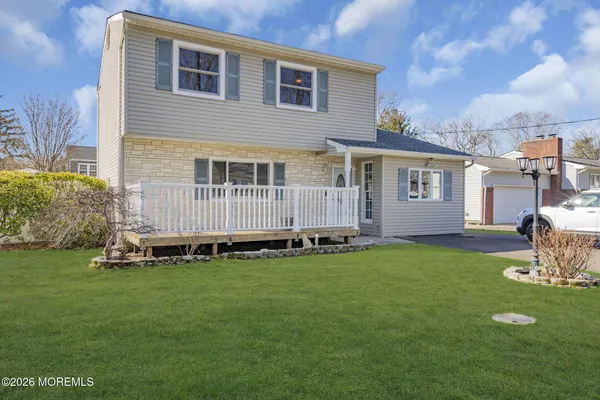 a backyard of a house with table and chairs