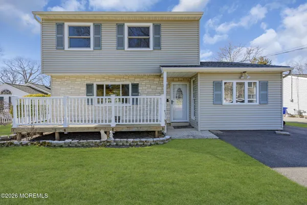 a view of a house with a yard and deck